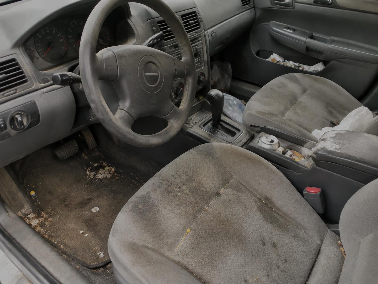 Car interior before detailing, dusty and stained